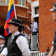 Assange surrounded by police outside the Ecuadorian Embassy in 2012.